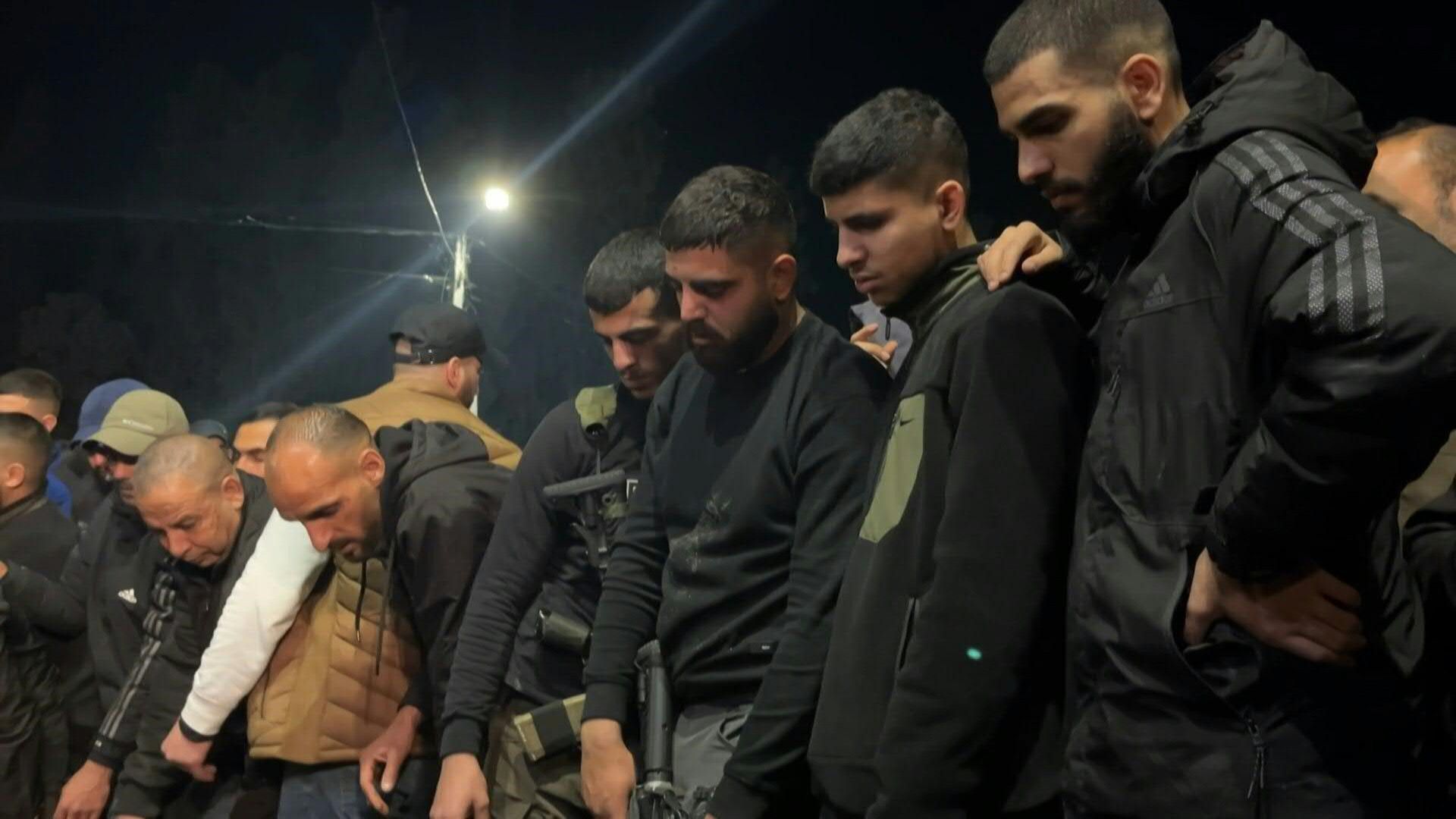 Palestinians gather at the funeral of three people killed in a West Bank Israeli strike