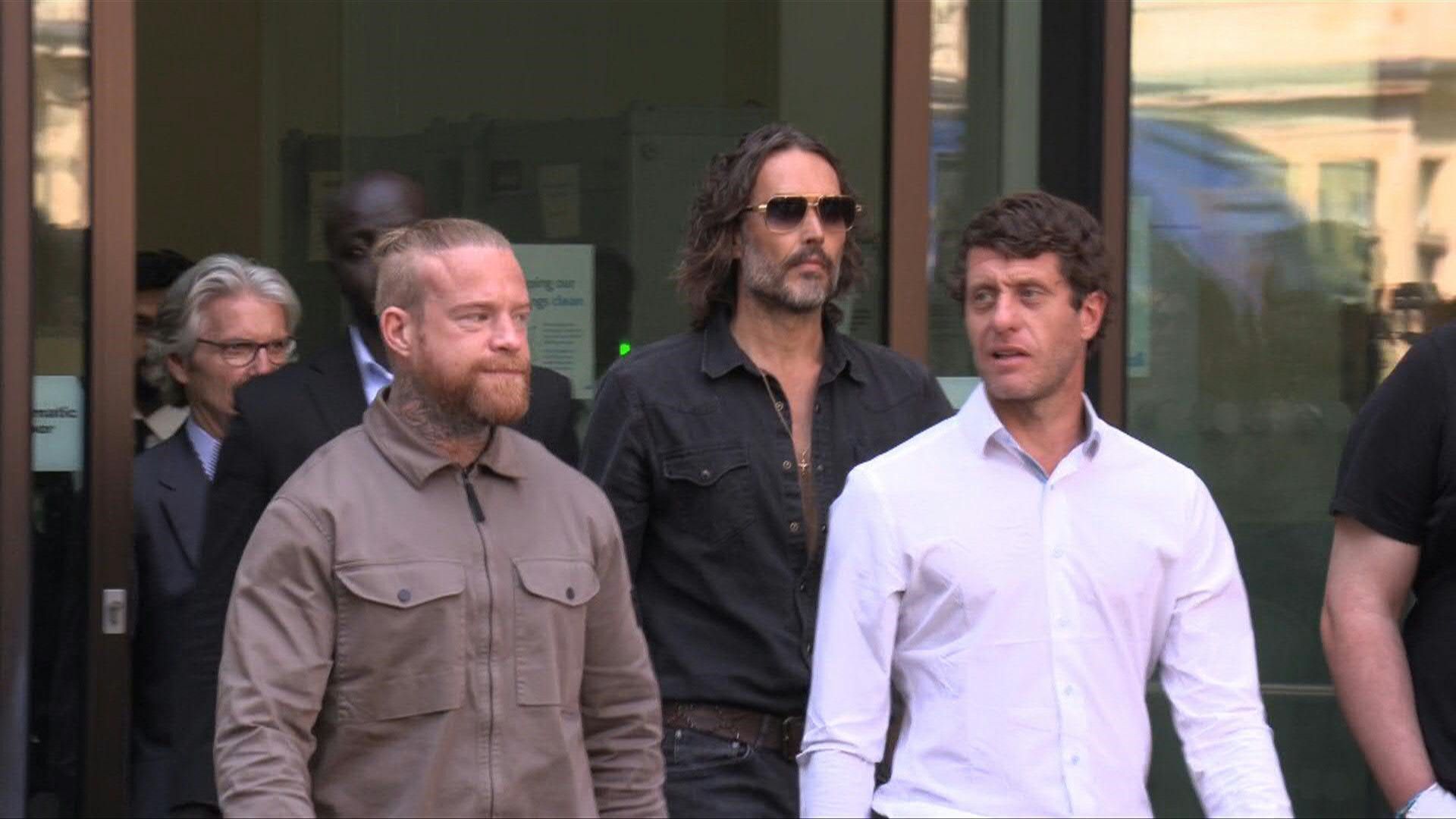 British comedian Russell Brand leaves court after first hearing for rape charges