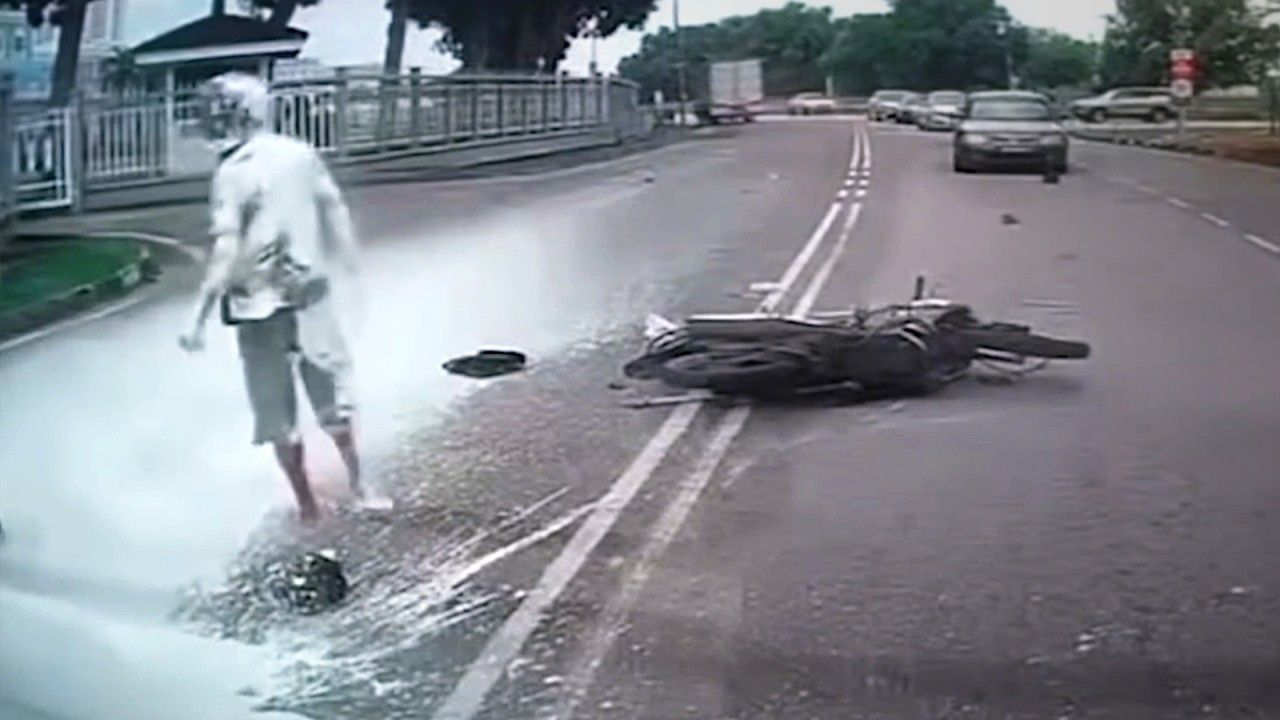 Video: Motorcyclist left covered in white paint as truck slams into him