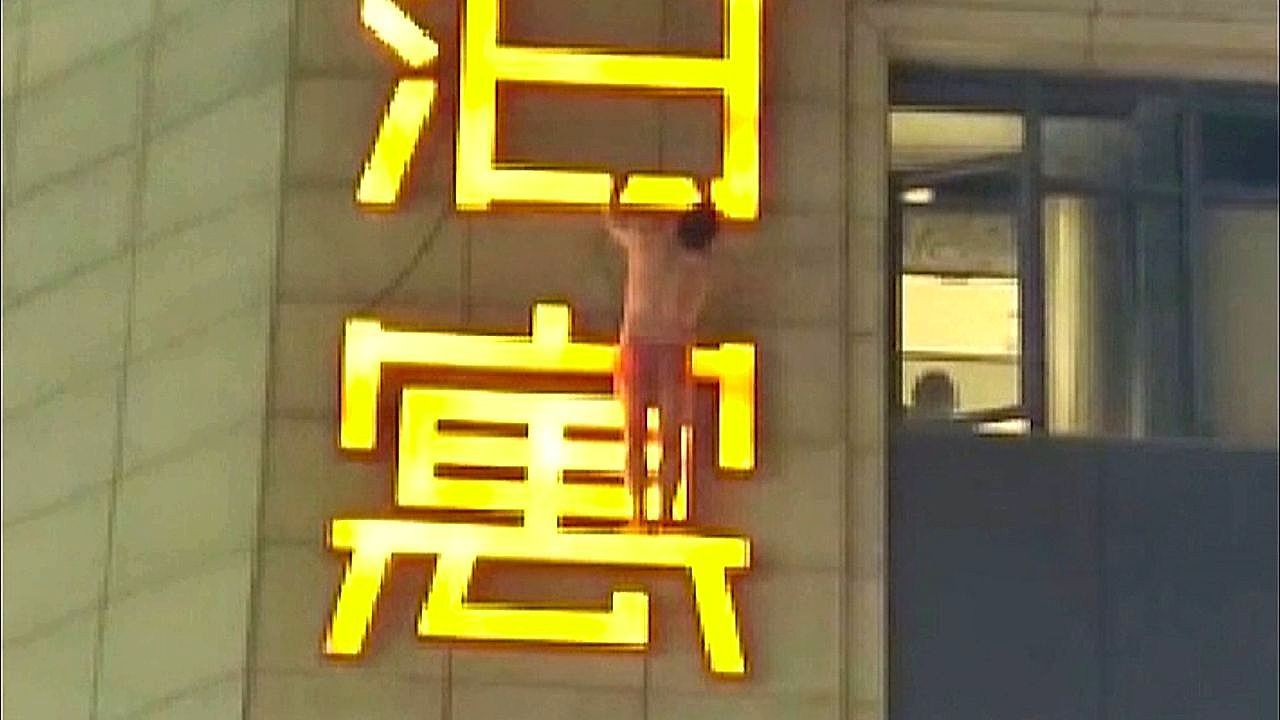 Video: In Boxershorts: Mann hängt bei Fluchtversuch an Hotelschild