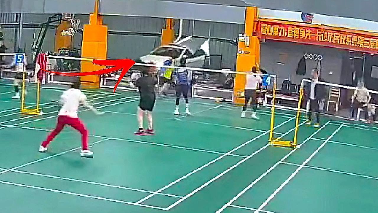 Video: Car bursts through indoor badminton court sending players running