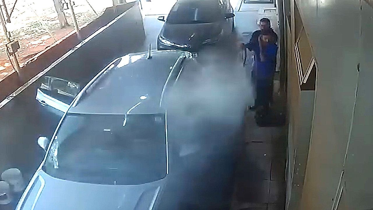 Petrol station workers in Brazil try to fight off swarm of bees