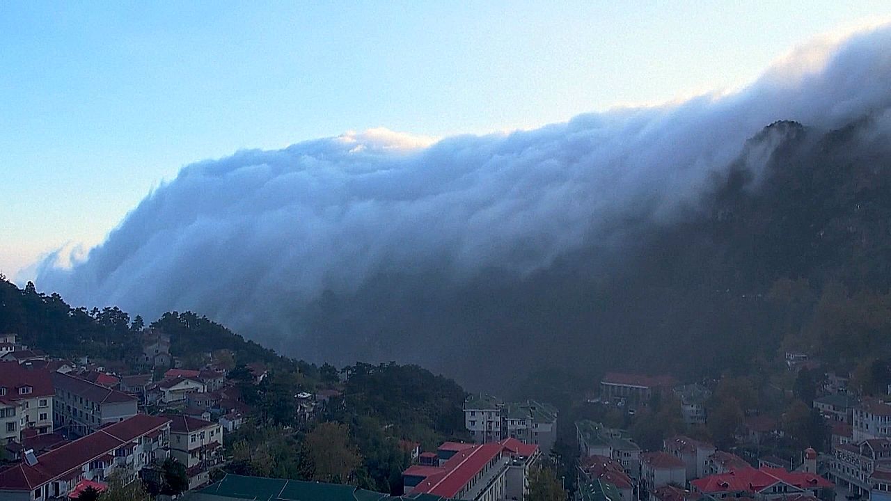 Utterly entrancing cloud waterfall spills over mountains in China