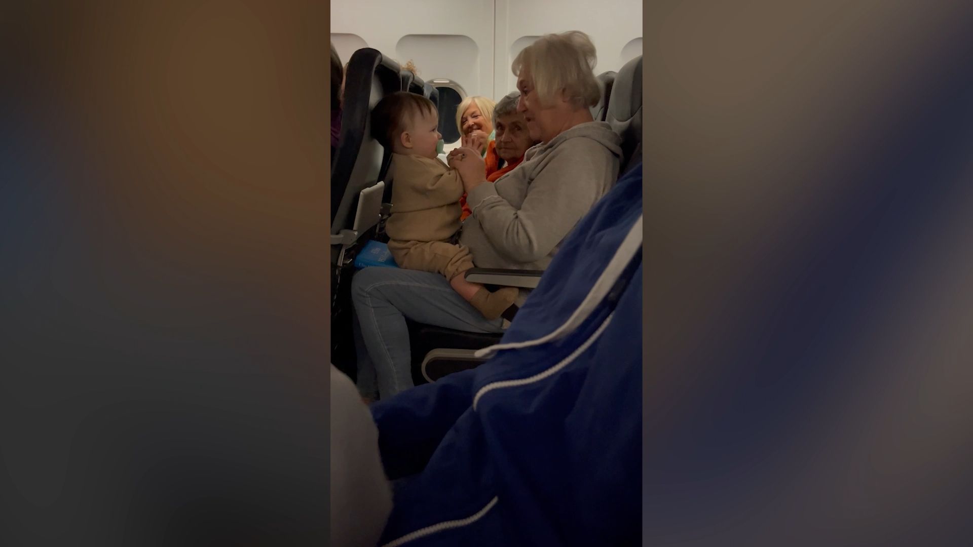 First flight: Helpful elderly ladies help mother with crying baby